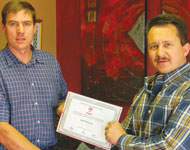 Mel Wilmans (right) receiving certificate of recognition from Eben Grobbelaar